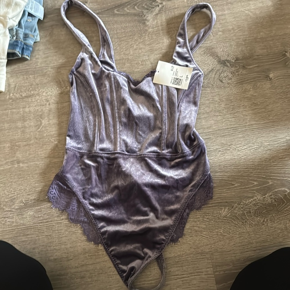 NWT purple felt material body suit.